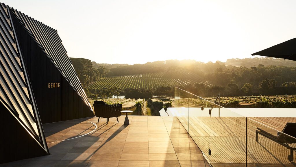 The deck looking out over Jackalope Hotel Mornington Peninsula's infnity pool and vineyards, the makings for country Victoria's best luxury accommodation - Luxury Escapes