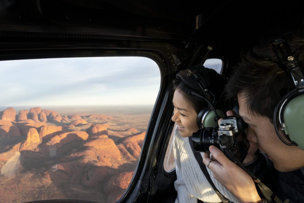 Couple viewing Kata Tjuta from a scenic helicopter flight