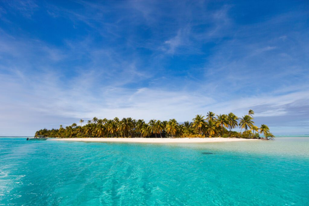 One Foot Island, Aitutaki, surrounded by turquoise waters - Luxury Escapes