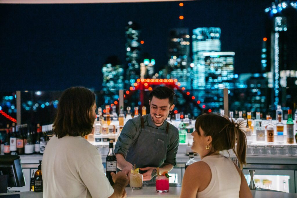 People at the bar at Iris Rooftop Bar, Brisbane, a must-visit destination perfect for a two-day itinerary in Brisbane