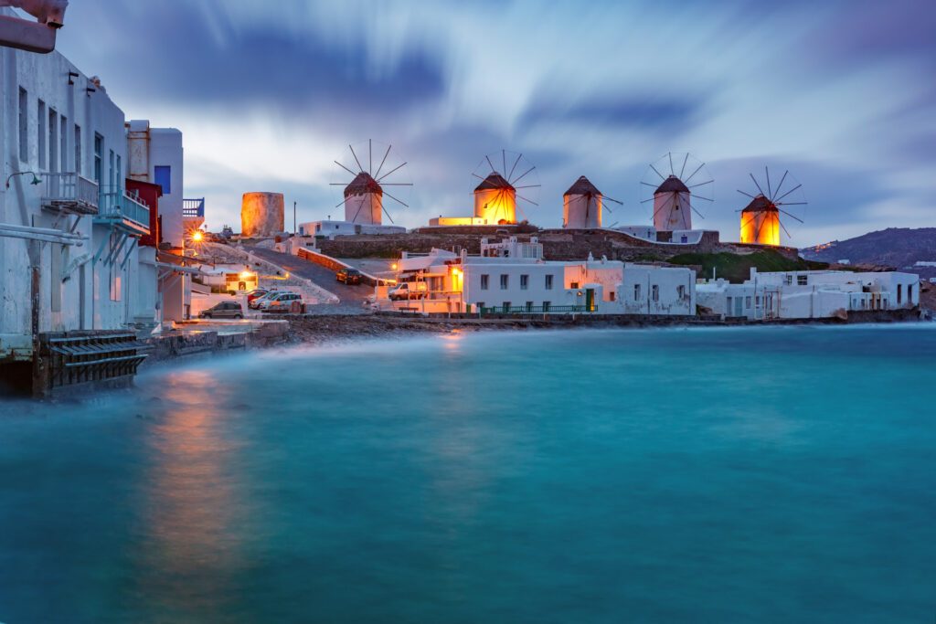 A stunning capture of The Seven Windmills of Mykonos, one of the best Greek islands - Luxury Escapes