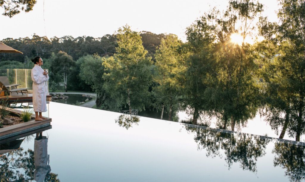 Lake House Daylesford's infinity pool looks out over the lake and surrounds trees, making it one of country Victoria's best luxury accommodation - Luxury Escapes