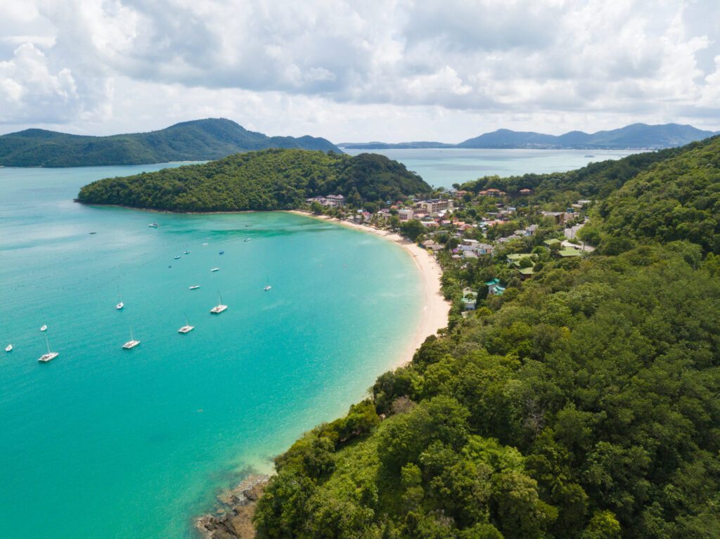 An aerial view of the bay, the Andaman Sea and rainforests at Amatara Wellness Resort, Cape Panwa, Phuket, one of the best beach resorts in Phuket, Thailand.