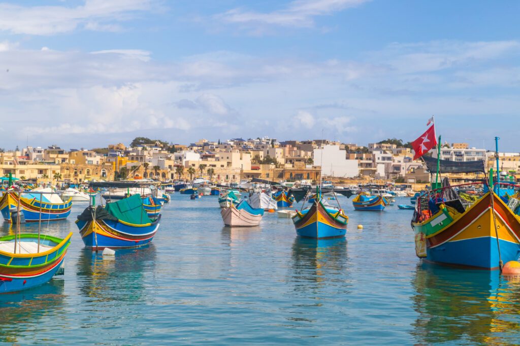 Colourful boats in Malta, one of the Top Bucket-List Destinations for 2023 - Luxury Escapes 