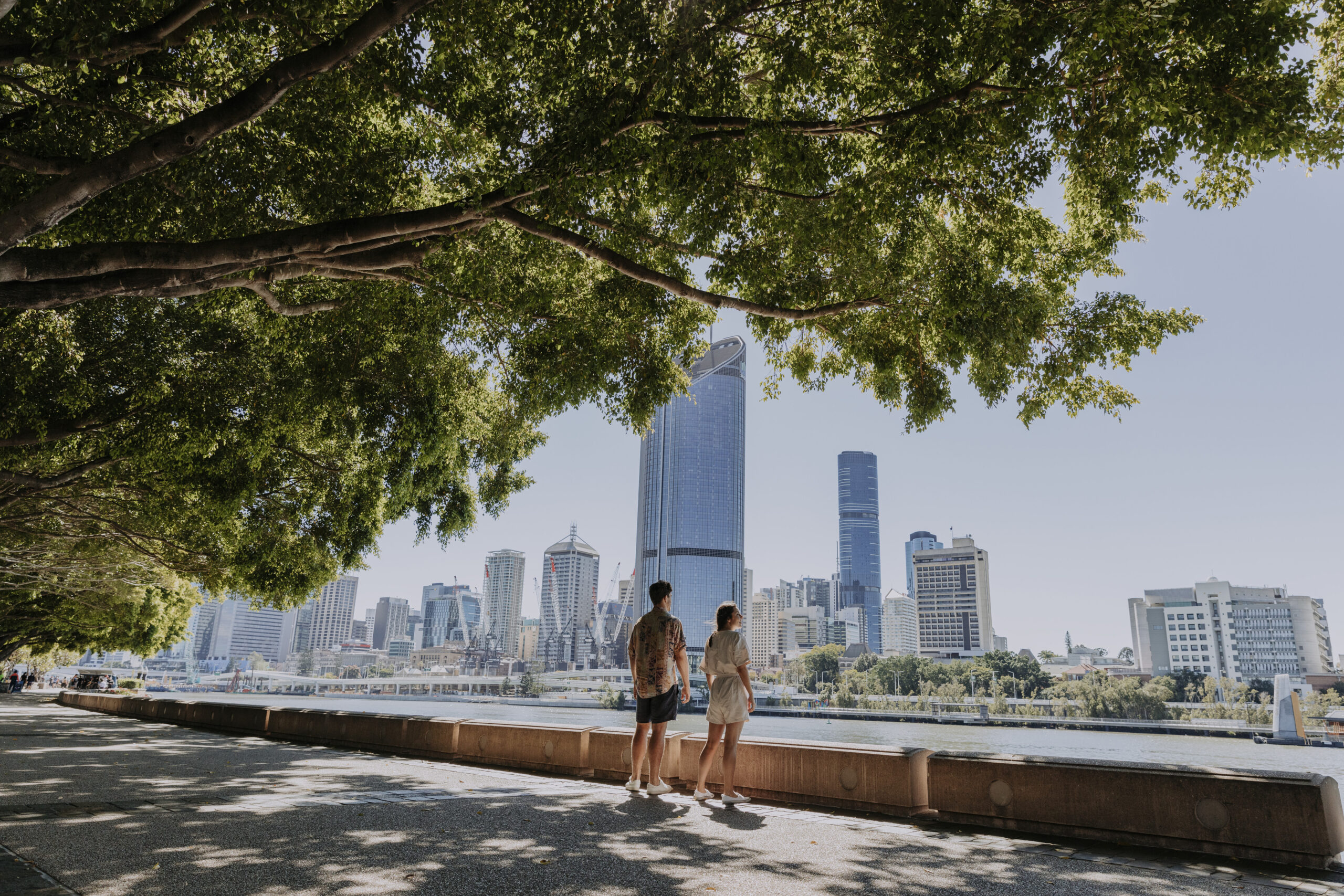 Couple walking along Brisbane River
