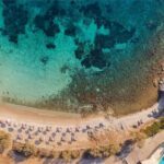 An aerial shot of the beach and Casa Del Mar Mykonos Seaside Resort in Mykonos, one of the best Greek islands - Luxury Escapes