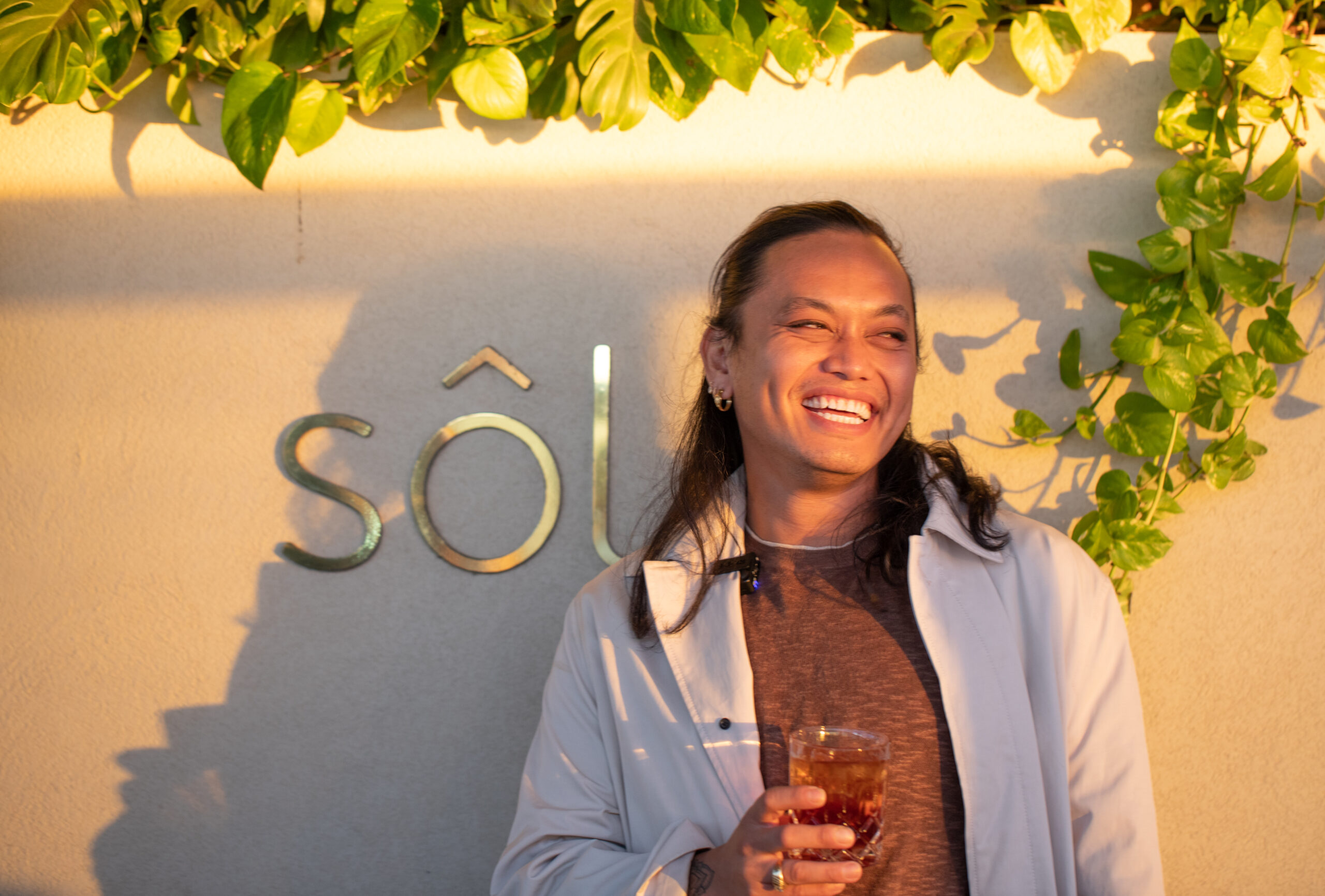 Adelaide's top restaurants with MasterChef Khanh Ong enjoying a sundowner at Sol Rooftop Bar with an exquisite drink - Luxury Escapes
