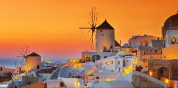One of the world's most beautiful sunsets can be witnessed at Oia in Santorini - Luxury Escapes
