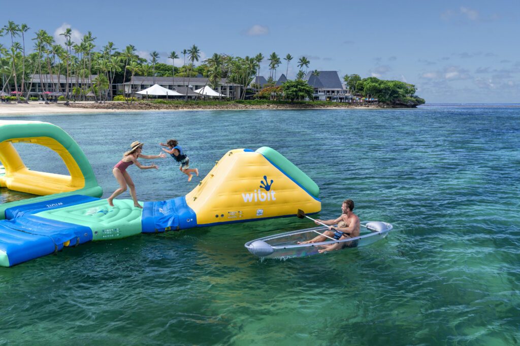 A family enjoying watersports at Shangri-La Yanuca Island, one of the best family-friendly resorts in Fiji - Luxury Escapes