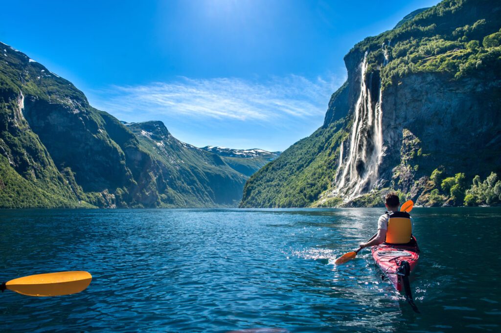 Kayaking in a fjord in Norway, one of the top tour destinations in 2024 - Luxury Escapes
