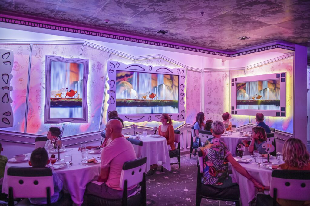 Interactive dining onboard the Disney Wonder at the themed Animator's Palate Restaurant, to illustrate why you should book with Disney Cruise Line for 2024 - Luxury Escapes