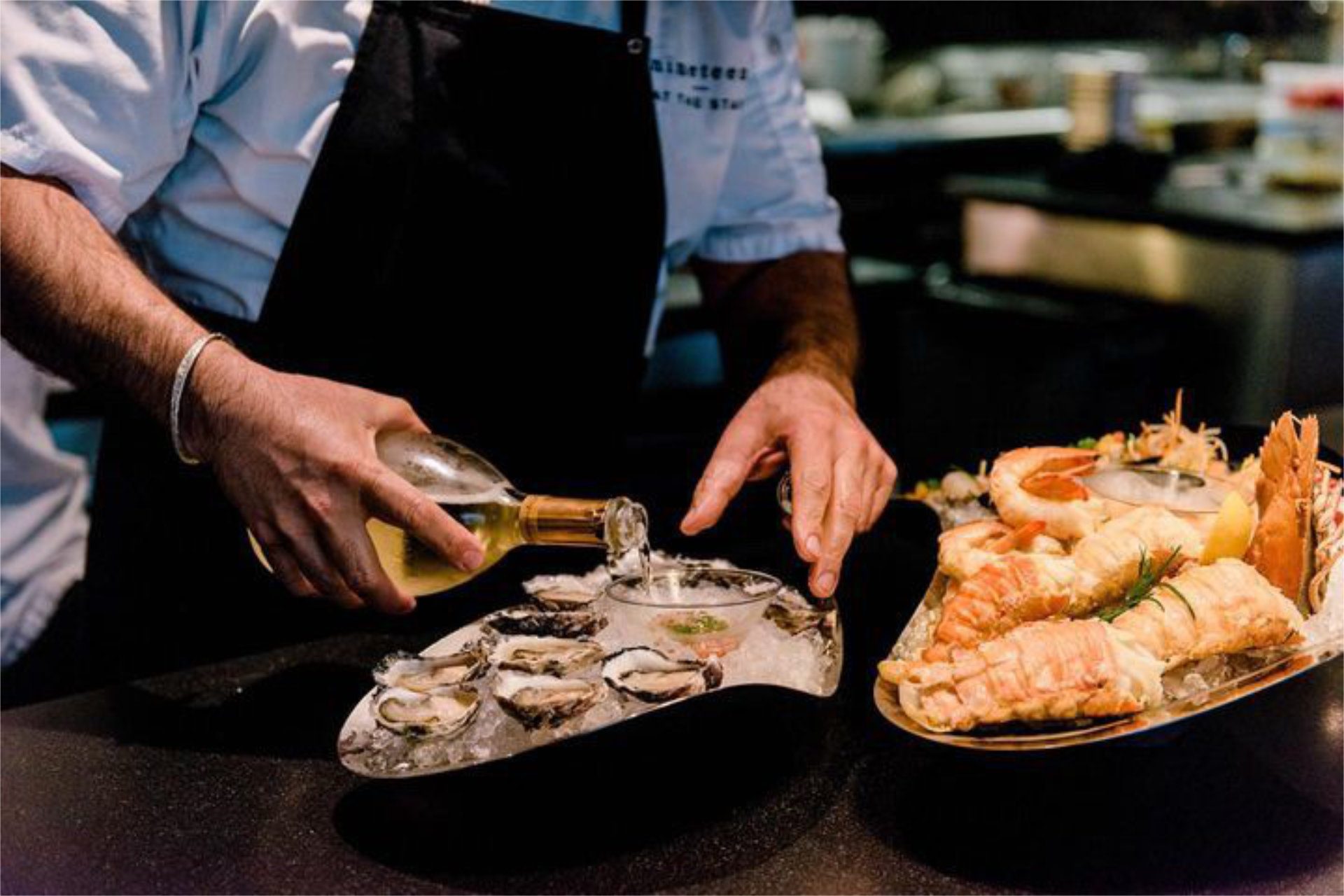 A plate of fresh oysters and lobster tails at Nineteen at The Star, one of the best Gold Coast romantic restaurants - Image provided, Luxury Escapes