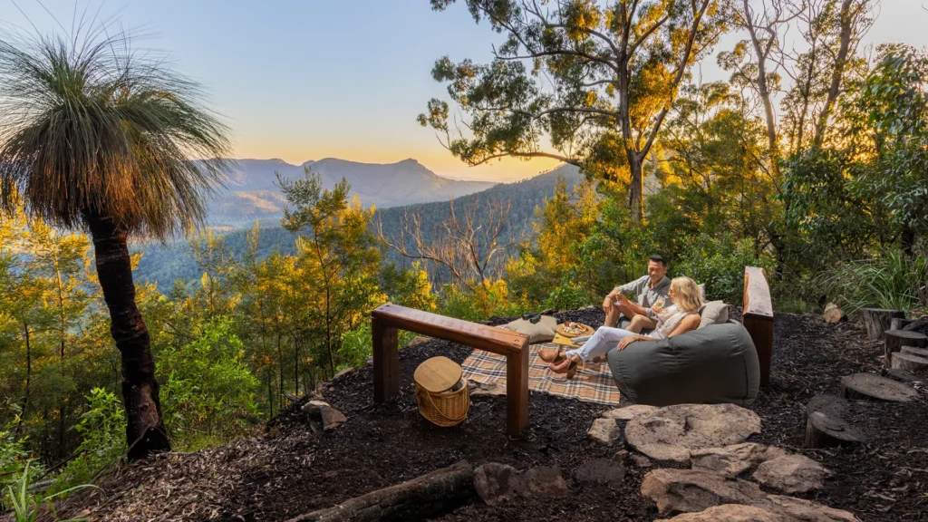 A couple enjoying a private picnic at Spicers Peak Lodge, one of Queensland's most unique stays - Luxury Escapes