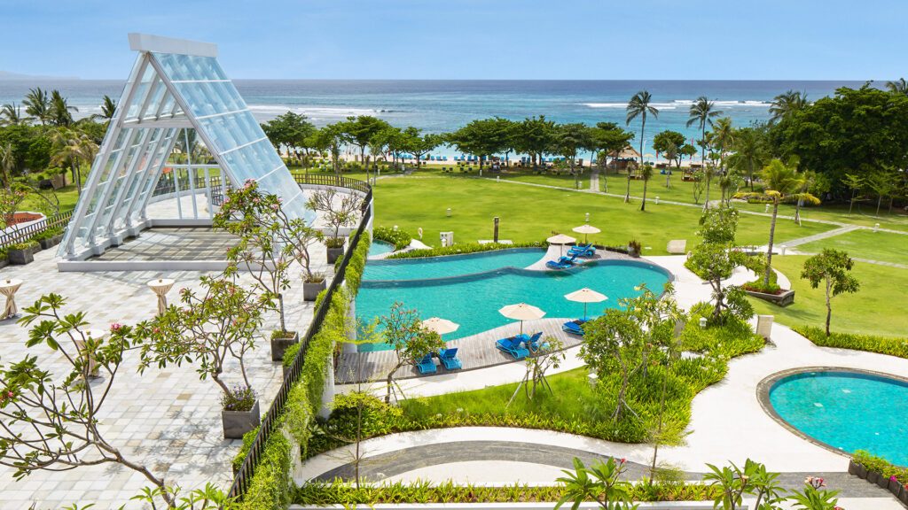 An aerial image of sparkling lagoon pools facing the pristine ocean front at Merusaka Nusa Dua one of the best family friendly resorts in the world - Luxury Escapes