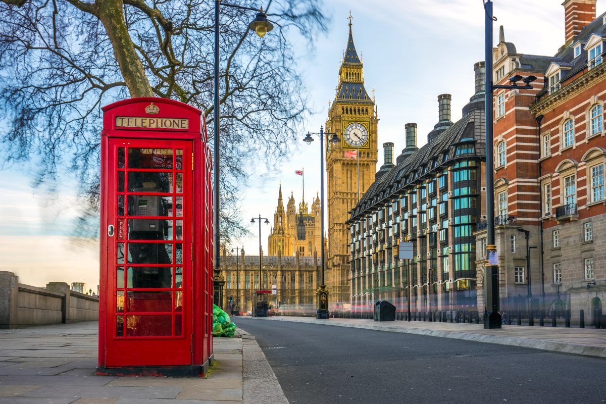 A red telephone booth, with Big Ben in the background - some of London's most iconic sights to experience - Luxury Escapes