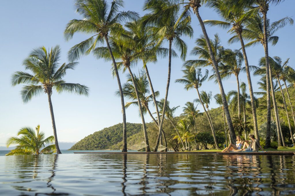 A couple enjoying the breathtaking views on the Orpheus Island Lodge, one of Queensland's most unique stay - Luxury Escapes