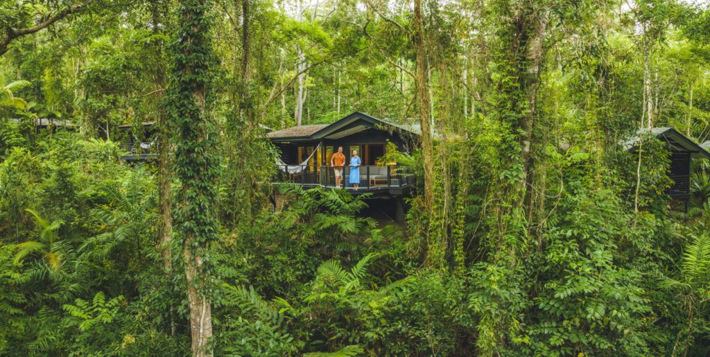 A couple enjoying the lush greenery at Silky Oaks Lodge, one of Queensland's most unique stay - Luxury Escapes