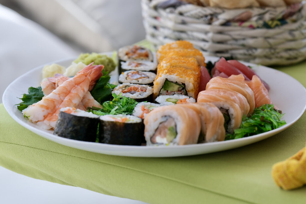 A plate of sushi on a green table in the Maldives - Luxury Escapes 