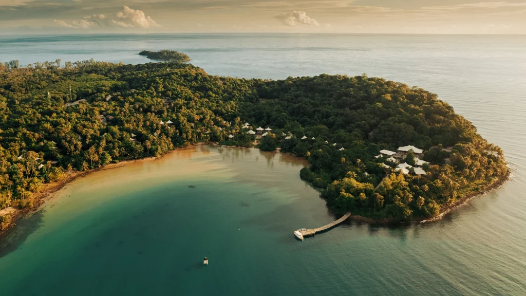 Aerial view of a lush Thailand island, one of Diana Chan and Cameron Daddo's favourite spots to travel in Thailand - Luxury Escapes