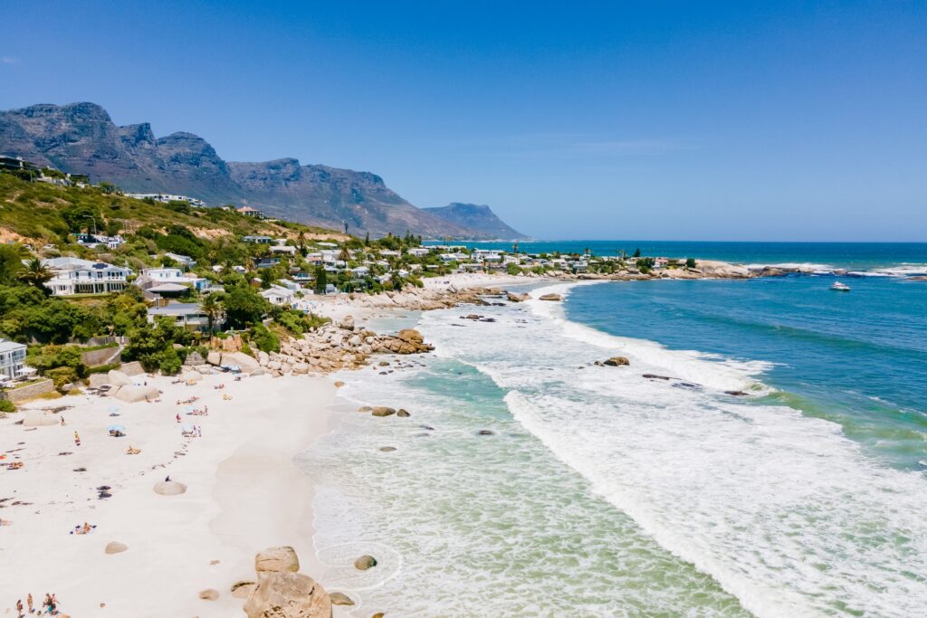 Coastal vibes at Camps Bay Beach, just a short drive from Cape Town, a place to visit when you spend a week in Cape Town - Luxury Escapes
