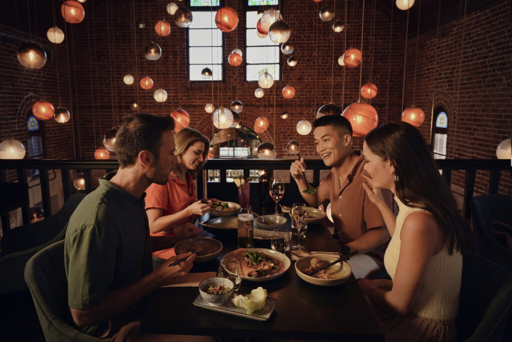 A beautiful image of people enjoying their food and a hearty conversation at Tonic and Ginger at The Old Synagogue, Fremantle - Luxury Escapes