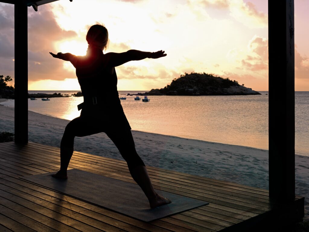 Appreciate the beauty of Lizard Island with a sunrise yoga session on the resort's decking - Luxury Escapes