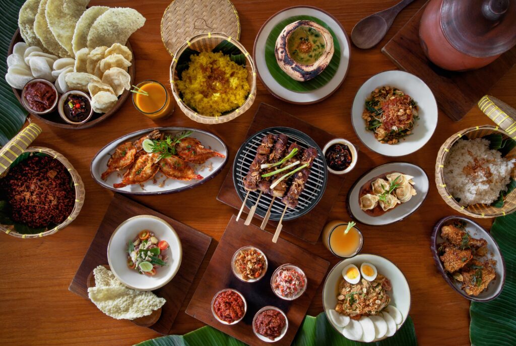 A spread if delicious food at Kaum restaurant in Potato Head Suites & Studios, Bali - Luxury Escapes