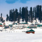 Snow drapes the slopes of Gulmarg, making it an ideal winter holiday destination in India.