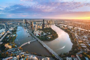 An aerial view over Brisbane and the Brisbane River, which weaves through the city. Brisbane's riverside precincts are just one reason the city is one of Australia's coolest capital cities.