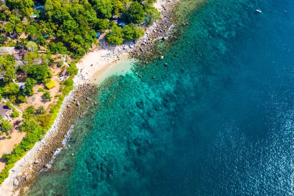 Aerial shot of Ao Sane Beach, whose calm waters and isolated shore makes it one of the best spots in Phuket to snorkel year-round