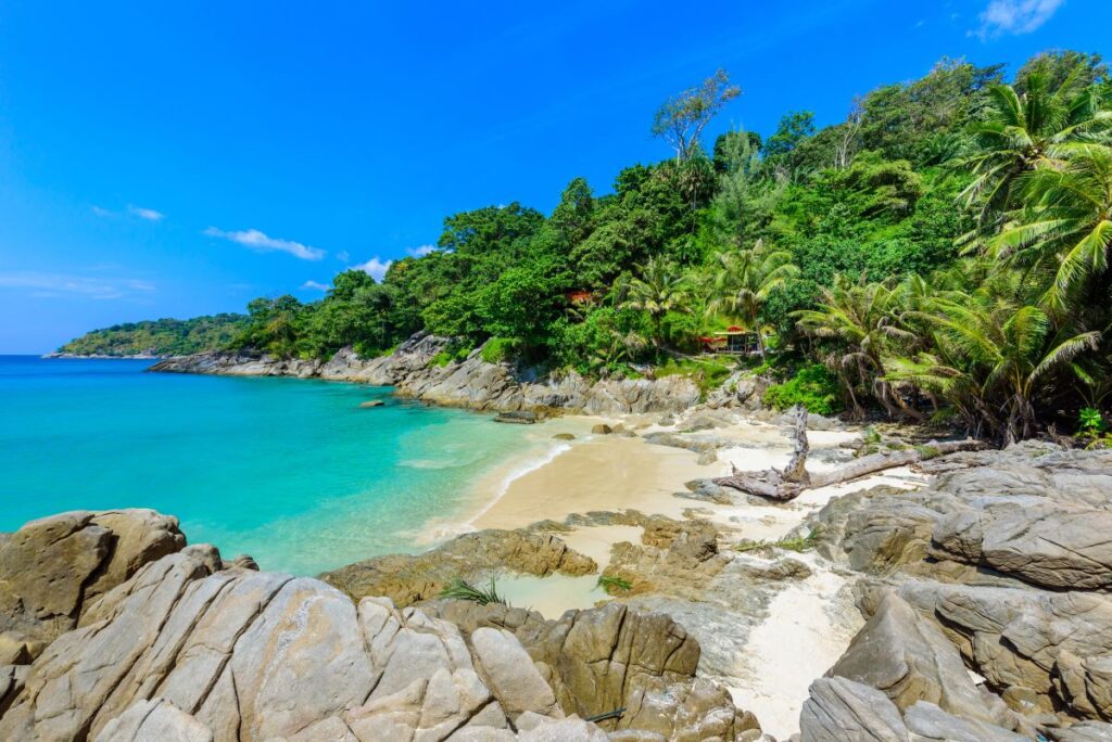 The rocky outcrops, golden sands and swaying palm trees of Freedom Beach in Phuket, which can only be accessed via longboat