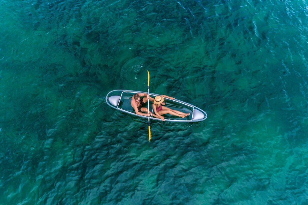 A couple kayak on clear blue seas while staying at Shangri-La Yanuca Island, Fiji one of the best places to stay in Fiji on a weekend away from Brisbane - Luxury Escapes