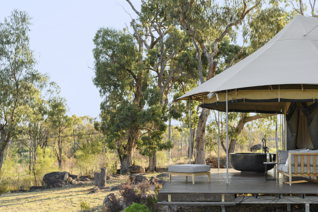 A glamping tent outdoors near the bush at Serenita Stanthorpe, one of Australia's best glamping destinations