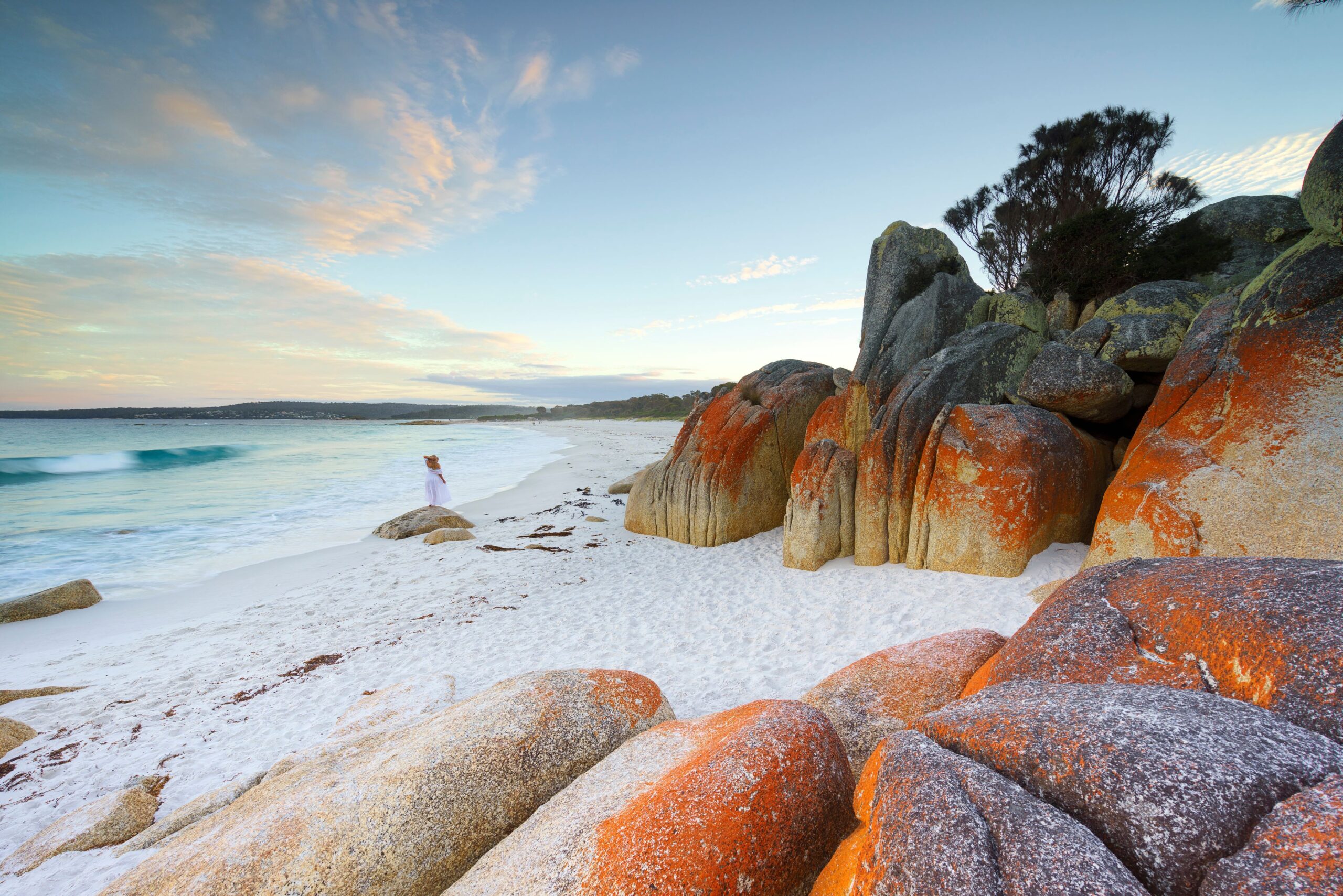 The Bay of Fires in Tasmania, one of the New York Times top 52 places to travel in 2024 - Luxury Escapes