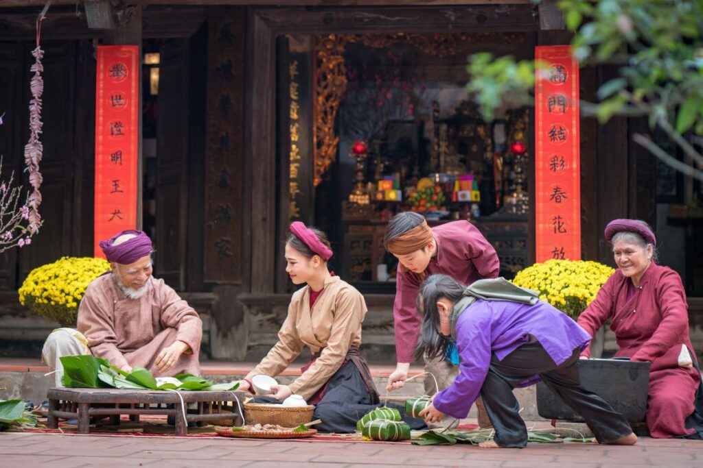 A family making Banh Chung during Tet, one of the traditions for Lunar New Year.