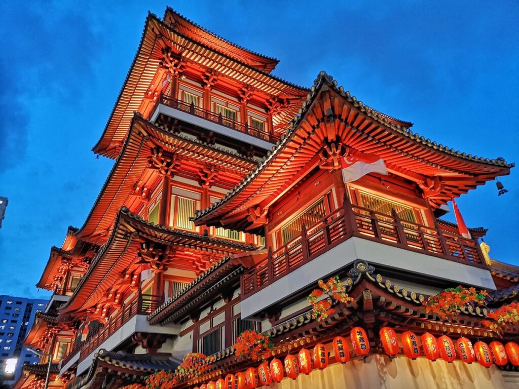 Decorated with red lanterns, Buddha Tooth Relic Temple in Singapore's Chinatown, which is a great place to enjoy the 2024 Lunar New Year celebrations - Luxury Escapes