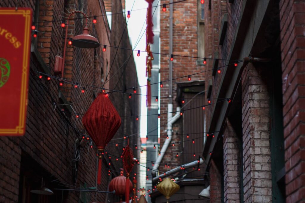 Chinatown in New York City, strung with red lanterns and lights, making the alley ways come alive for Lunar New Year 2024 - Luxury Escapes