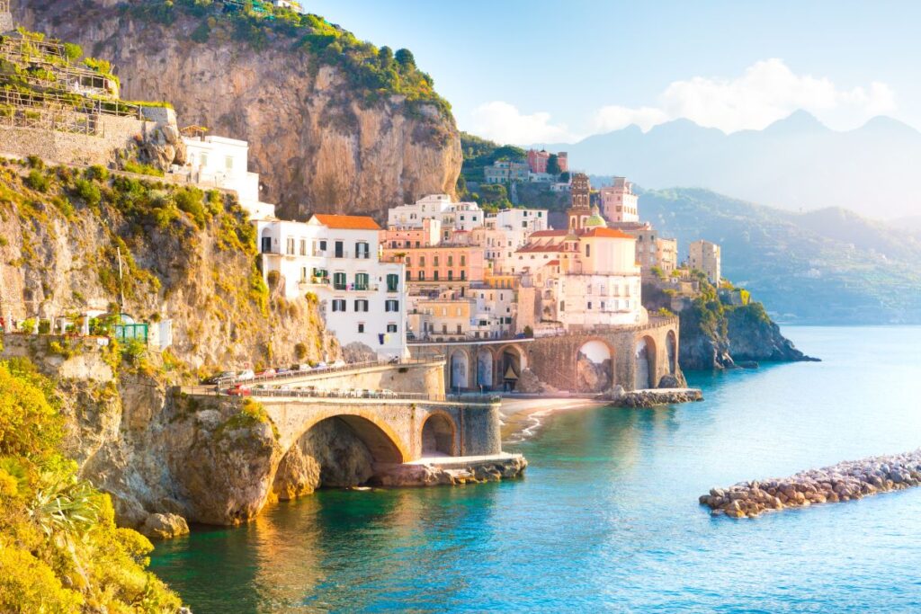 This cluster of buildings along an Italian cliff face is best explored during the Spring time - Luxury Escapes