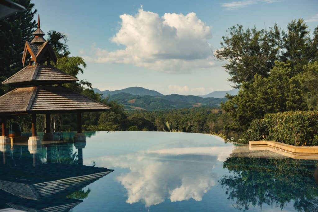 A reflective infinity pool at Anantara Golden Triangle Elephant Camp & Resort which is one of the standout properties in northern Thailand's golden triangle - Luxury Escapes