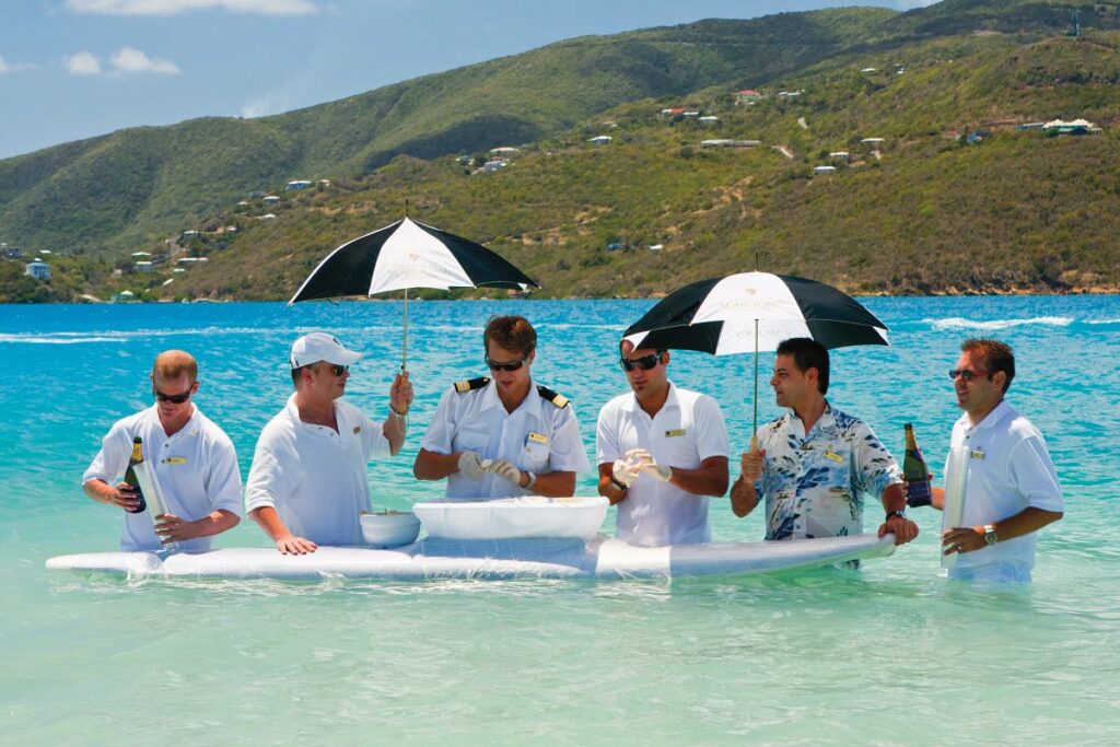 Cruise staff preparing caviar in the surf, one of the surprising things to do on a Seabourn cruise - Luxury Escapes