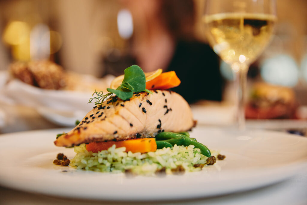 Salmon dish in the dining room of a Holland America Line ship - Luxury Escapes 