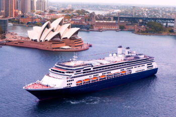 Holland America ship sailing past the Opera House in Sydney, facts about Holland America Cruise lines - Luxury Escapes