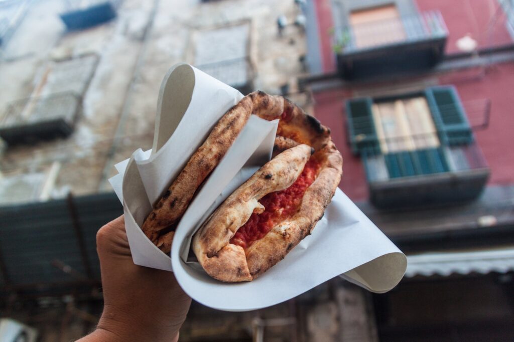 A folded pizza in Italy, one of the world's best destinations for street food - Luxury Escapes 