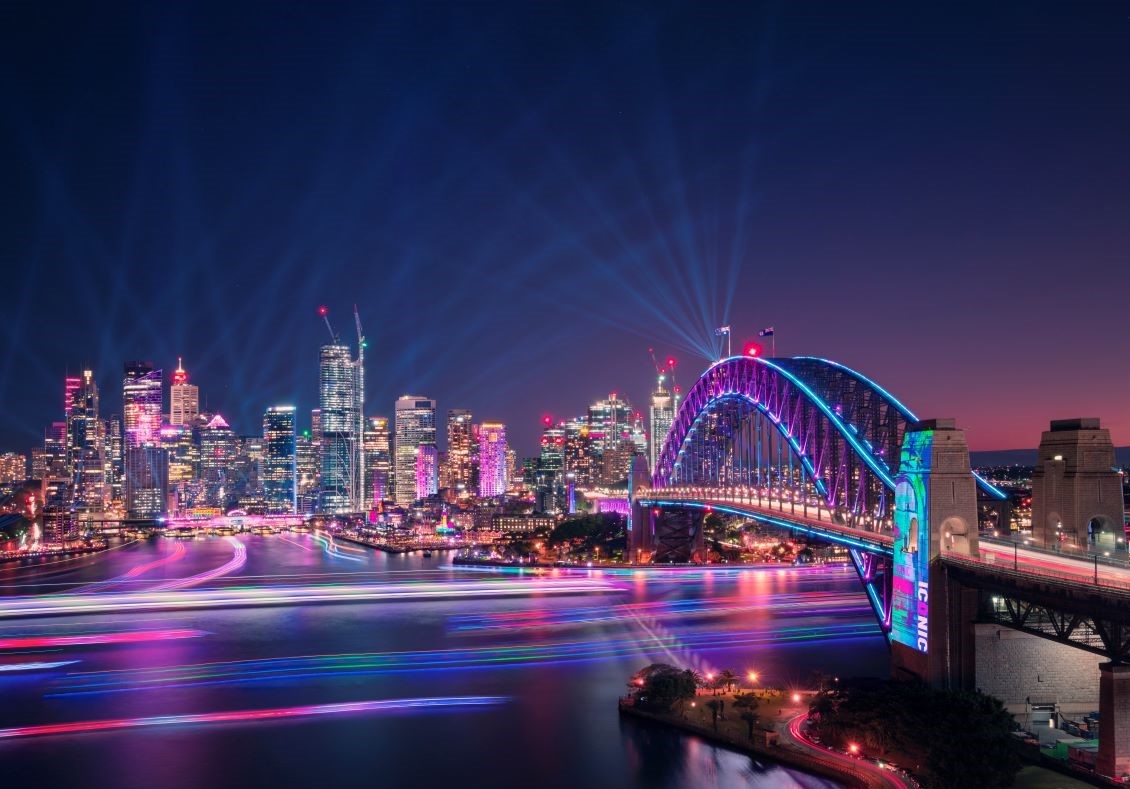 View of the Sydney Harbour Bridge illuminated during the Vivid Sydney festival celebrations - Luxury Escapes