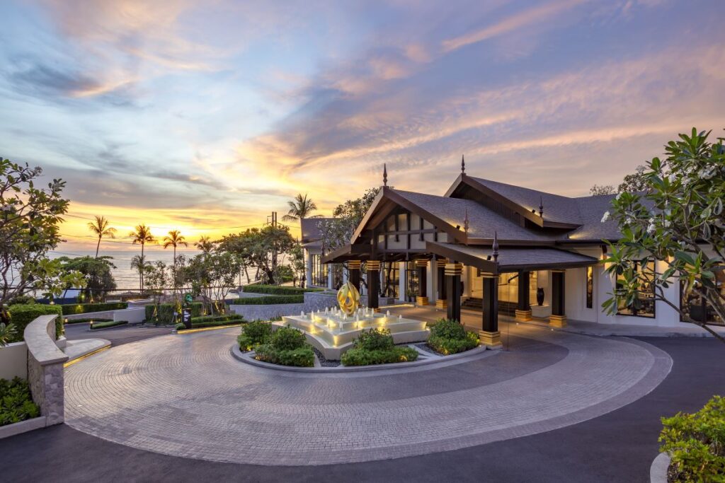 A paved drive way and front building of Diamond Cliff Resort and Spa, one of Phuket's best resorts - Luxury Escapes