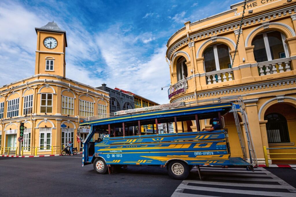 A blue bus drives past Phuket's Sino-Portuguese buildings on the Old Town, one of the best places to explore in the city - Luxury Escapes 