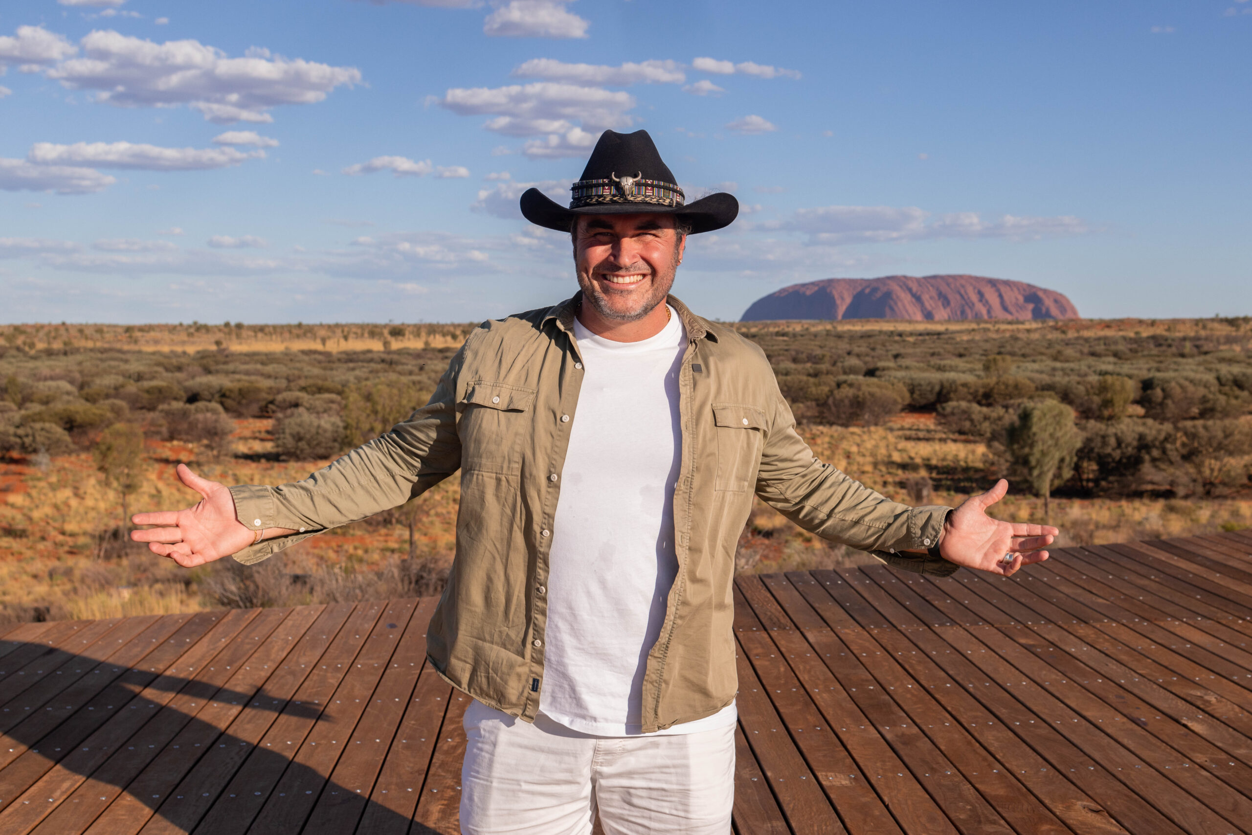 Miguel Maestre standing in front of Uluru - Luxury Escapes