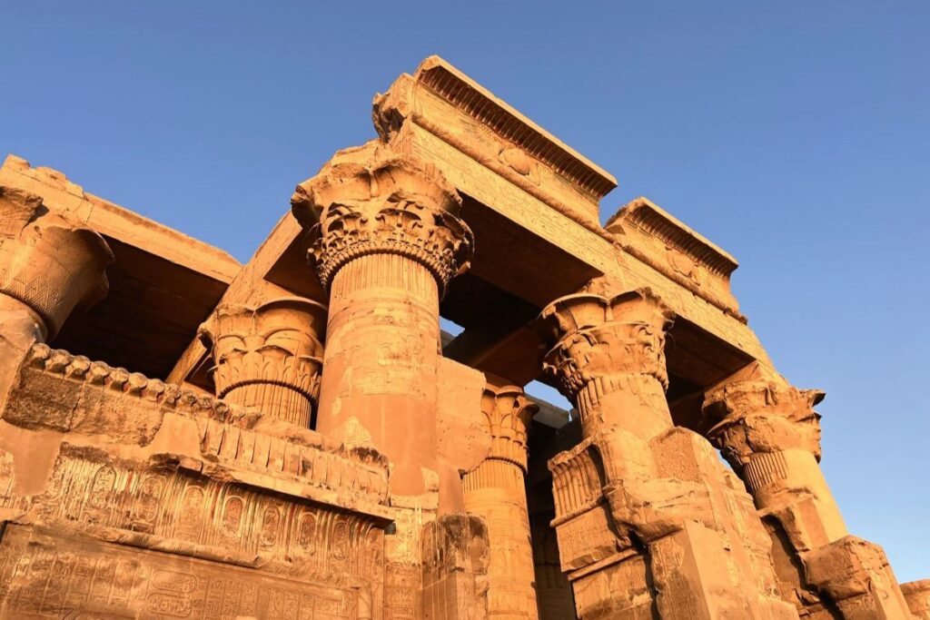A detailed roof and pillars of the Komombo Temple, one of the best spots to visit while touring Egypt - Luxury Escapes