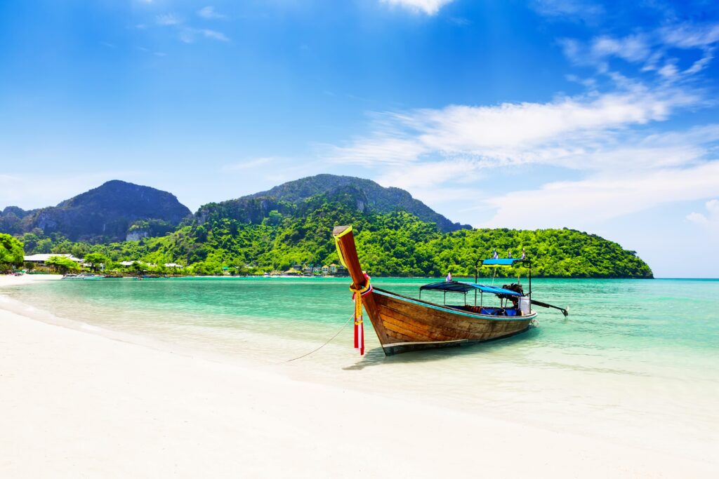 A traditional Thai longboat on the shores of Koh Samui - Luxury Escapes