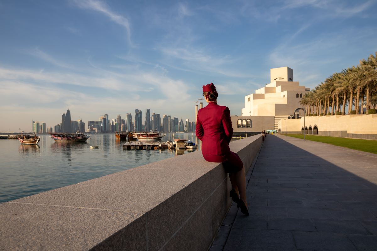 Doha, featuring a member of Qatar Airways cabin crew, which recently welcomed Sana 2.0 as the world's first AI flight attendant - Luxury Escapes